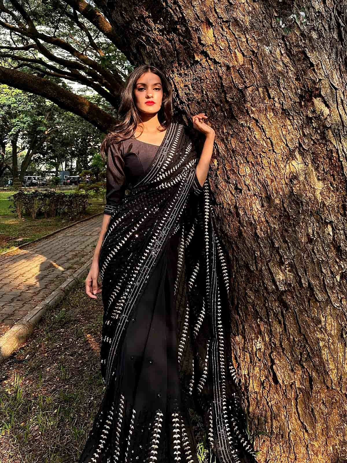Divi Vadthya Poses With A Firearm Clad In A Silk Saree