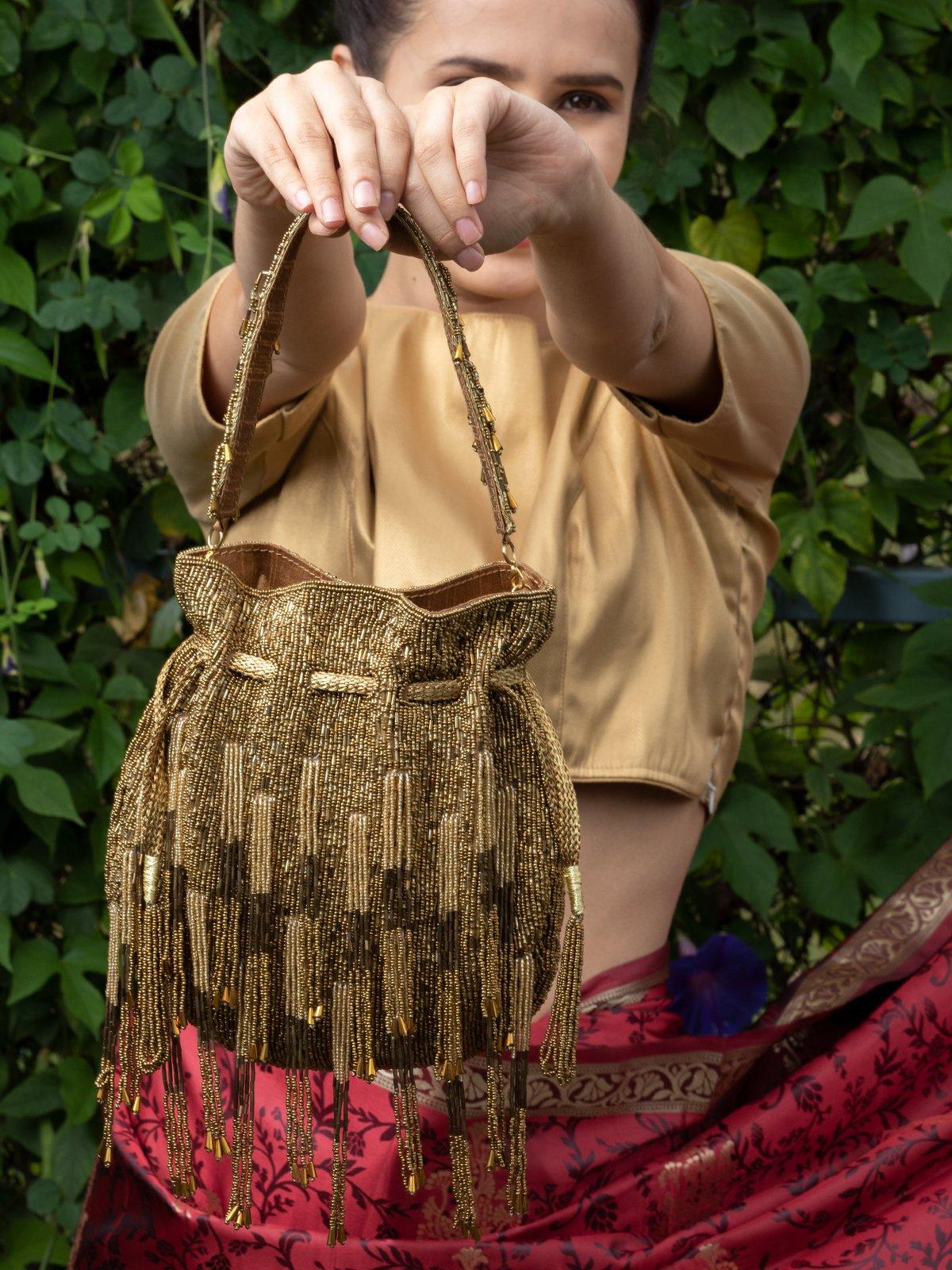 Buy Deep Gold Studded Tassel Potli Bag Online. Odette